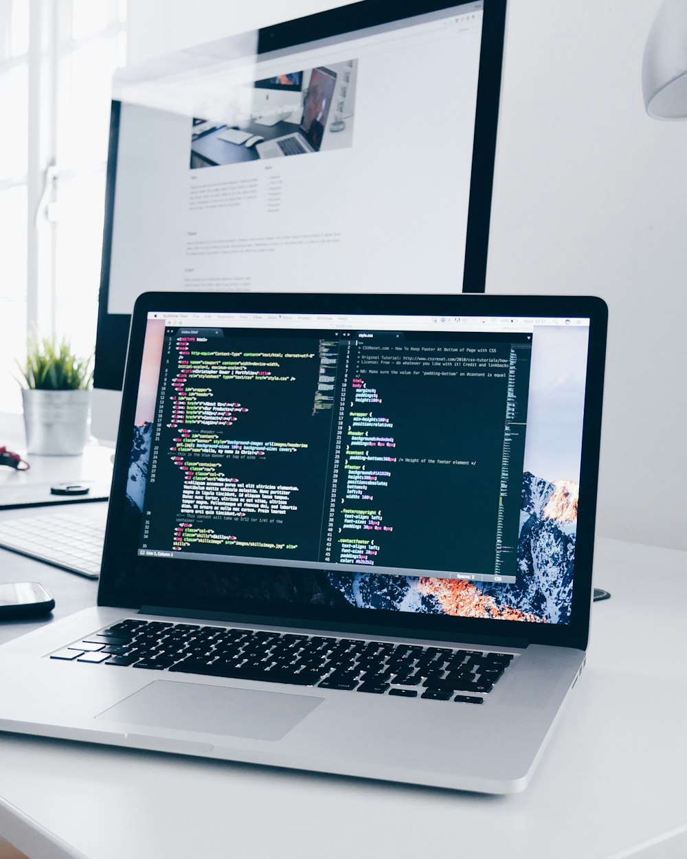 Creative workspace with code on screen